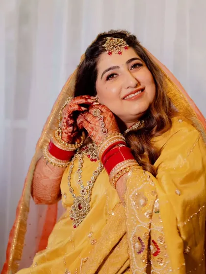 Capturing the joy of this bride's wedding ceremony. Her makeup is traditional and radiant, with warm tones and defined eyes, paired with soft waves for a look that is both classic and effortlessly beautiful.