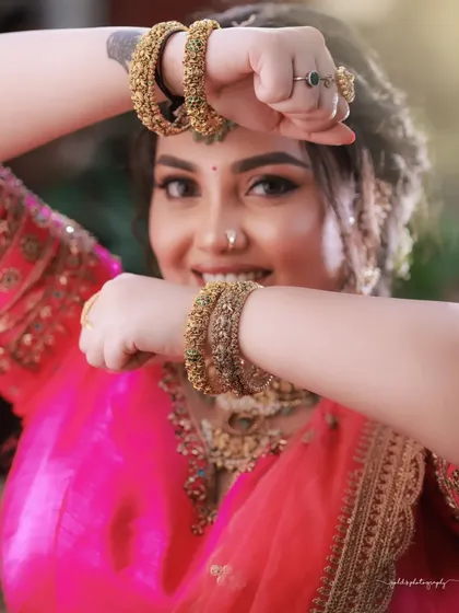 Another joyful close-up, this time with the bride showing off her beautiful bangles. It's a shot full of life and personality.