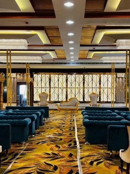 A luxurious setup at Grand Utsav banquet in Kharghar, featuring deep teal sofas and a golden mandap. This hall is perfect for a royal-themed wedding.