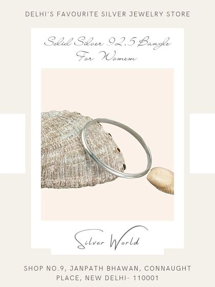 A classic, solid round silver bangle. This timeless piece is a staple in Indian jewelry and is known for its durability and simple elegance.