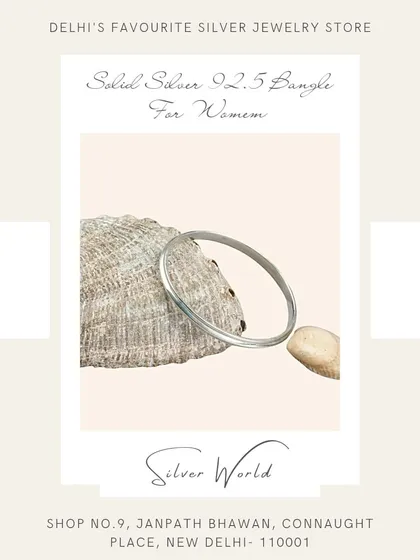 A classic, solid round silver bangle. This timeless piece is a staple in Indian jewelry and is known for its durability and simple elegance.