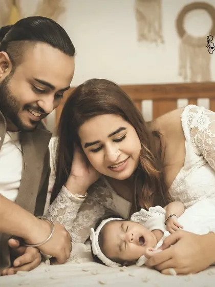 That tiny yawn says it all. I love capturing these authentic, unscripted moments during a newborn session. The parents look on with so much adoration.