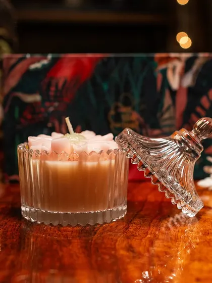 This beautiful pink floral candle in a fluted glass jar is a highlight of my Diwali gift box. Its delicate design and soothing scent make it a perfect item for creating a peaceful, festive mood.
