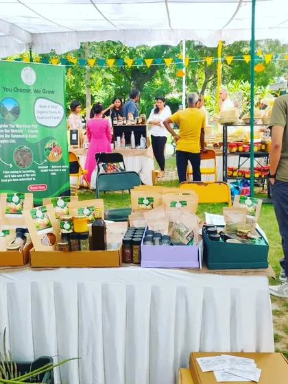 We love connecting with the community at local events and markets. This is our setup at a recent farmers' market, where we can showcase our produce and talk to people about the benefits of organic living, a service we regularly bring to residential societies.