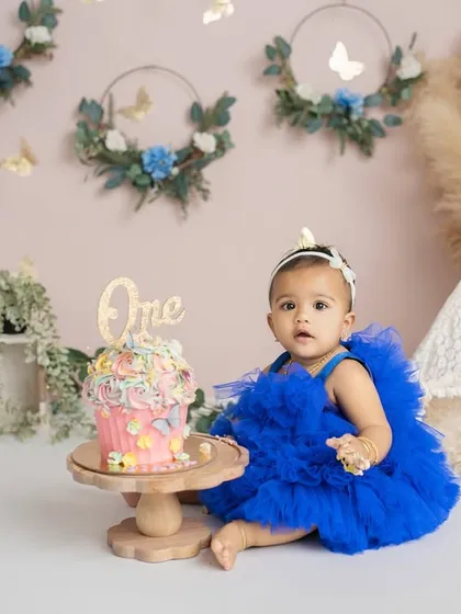A beautiful setup for a beautiful girl. This boho-themed cake smash features a custom cake, a lace teepee, and delicate floral details.