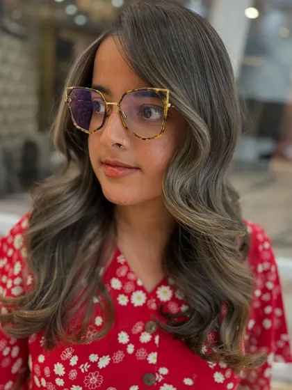 The side profile of this ash blond balayage shows the beautiful, smoky highlights.