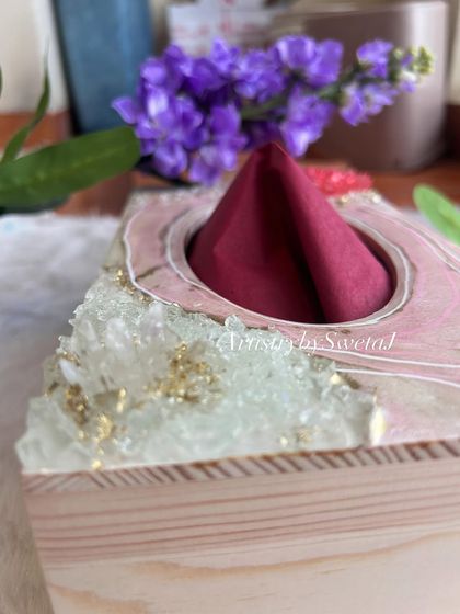A close-up of the crystal and gold flake details on the napkin holder. It's a functional piece that doubles as a piece of art for your dining table.