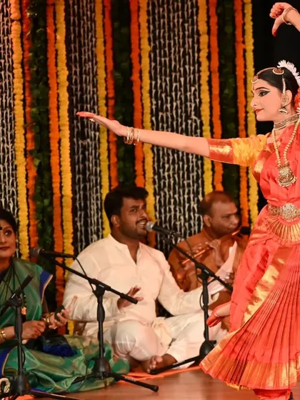The beauty of Bharatanatyam lies in its ability to convey stories through graceful movements. Here, Kavya Navani performs during her arangetram, her form perfectly complemented by the live music ensemble.