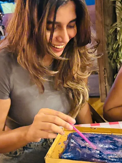 This picture captures the pure, unscripted joy of our workshops. A participant lost in the moment, laughing while creating. It’s not about the finished product; it’s about the feeling you get along the way.