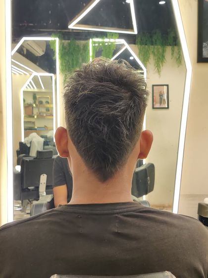 The back view of a V-shaped mullet, a timeless and individualistic men's hairstyle.