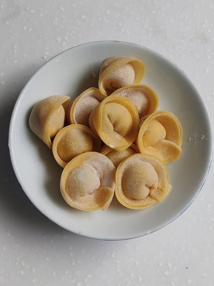 Perfectly shaped tortellini, waiting to be filled and cooked. This is a skill that requires patience and practice.