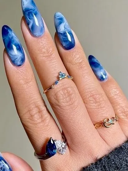 This set is inspired by the deep blue hues of a lapis lazuli stone. The rich blue and white marble effect is mesmerizing, giving the nails a look of natural, polished stone.