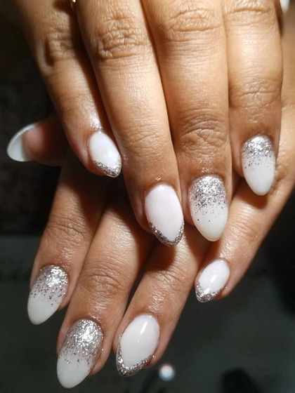 Minimal glitter nails are perfect for a subtle bridal look. This design features a milky white base with a beautiful silver glitter gradient.