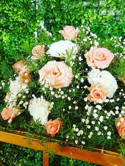 Another look at a delicate floral bouquet, showing the soft colors and textures of the roses and carnations. These small arrangements can be used as centerpieces or accents.