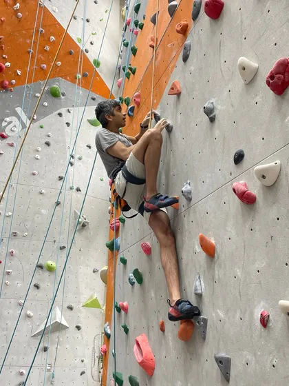 A climber navigates a tricky sequence, using precise footwork and body positioning to conserve energy.