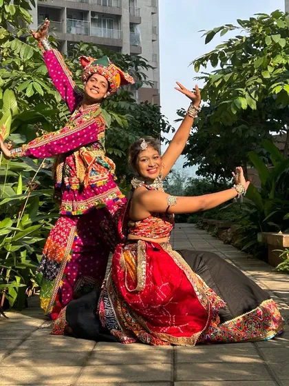 A beautiful seated pose that shows how stunning these outfits are even when you're taking a break from dancing.
