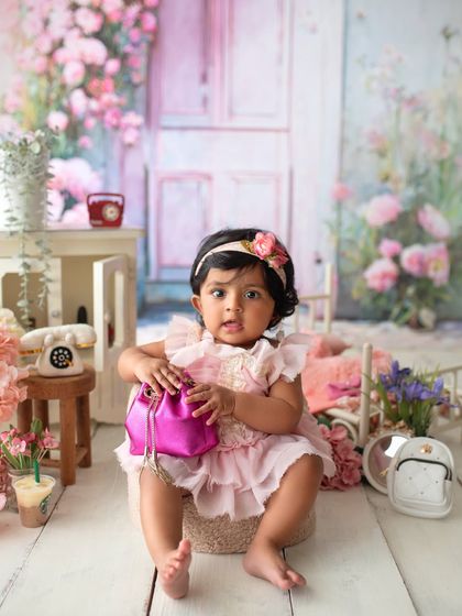 This little fashionista is checking out her new purse. Themed sessions are a great way to capture your baby's budding interests and personality.