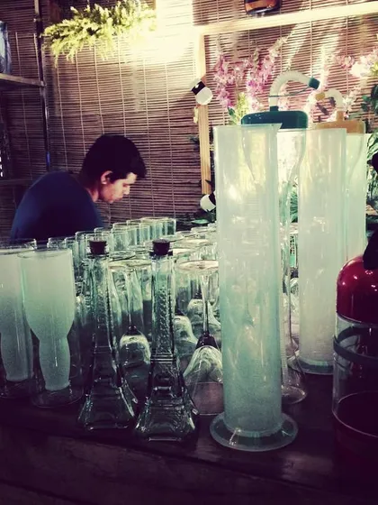 A collection of our unique glassware, including Eiffel Tower-shaped bottles and tall lab-style cylinders, ready for a molecular gastronomy event.