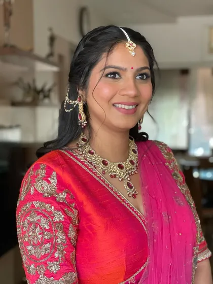 A beautiful portrait of the client. The half-up style with braided details is perfect for a Mehendi or Haldi ceremony.
