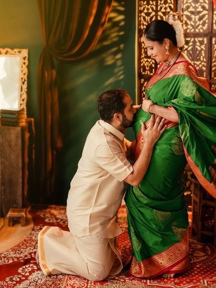 A tender moment in a traditional setting, as the father-to-be kisses the baby bump. This shot beautifully captures the love and reverence of the couple's journey.