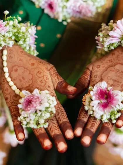 The beauty is in the details. Here, the dark henna stain is adorned with delicate floral hand jewellery, a popular choice for baby showers.