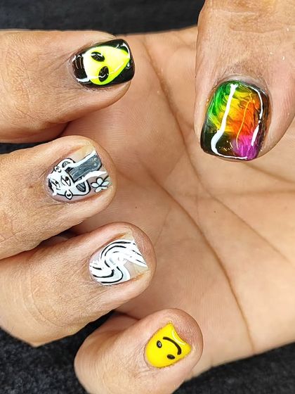 A different view of this eclectic set, showing off a rainbow feather design on the thumb. It's all about mixing and matching to create your own vibe.