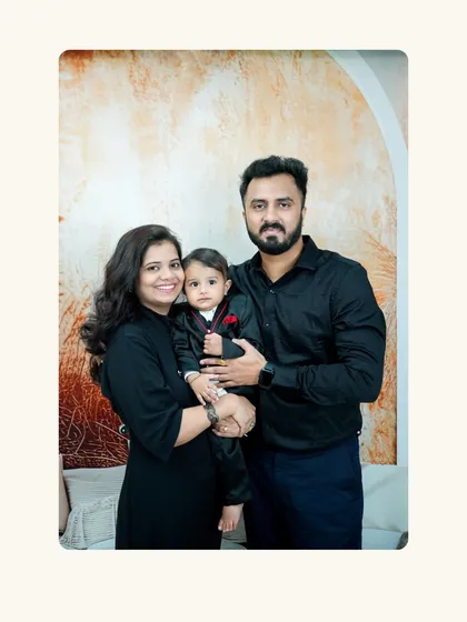A classic family portrait for a first birthday. Coordinating outfits and a simple, elegant backdrop make for a timeless photo you can display for years.