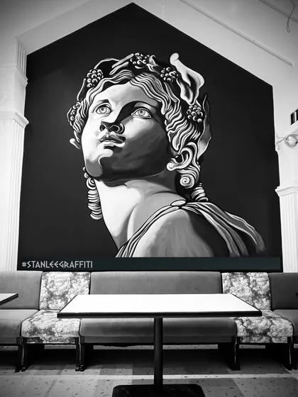 The finished 15-foot Roman-style portrait for a restaurant in Indore. The high-contrast monochrome design creates a dramatic and classical focal point in the dining area.