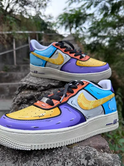 Could these BE any cooler? A sketchy, colorful pair of Air Force 1s inspired by the TV show Friends. The color blocking is based on the iconic door and couch from the show.