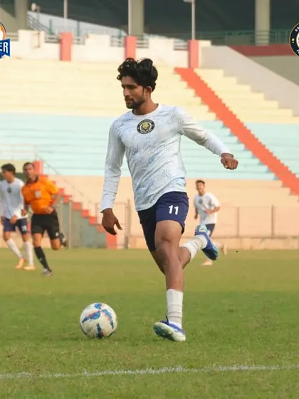 A player runs with the ball, showcasing the fitness and drive of our squad.