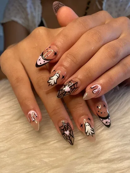 Getting into the spooky season with this detailed Halloween nail art. This custom set includes hand-painted ghosts, spiderwebs, and drip effects on long, clear stiletto extensions.