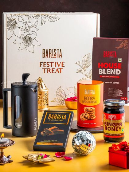 A Barista "Festive Treat" coffee-themed gift box, including a French press, coffee beans, and chocolates, styled for Diwali.
