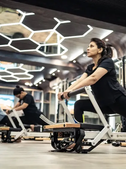 Here you can see the energy of a group reformer class. Each client is focused on their own lunge variation, building leg strength and stability in a supportive and motivating environment.