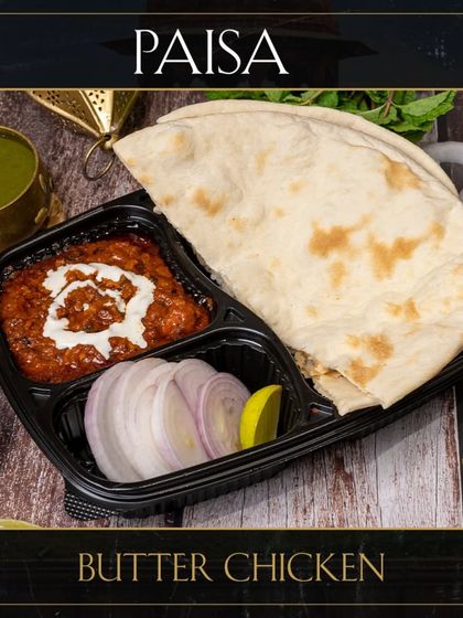 Our Butter Chicken combo, a complete meal for one. It comes with our signature gravy, fresh naan, and a side of onions and lemon.
