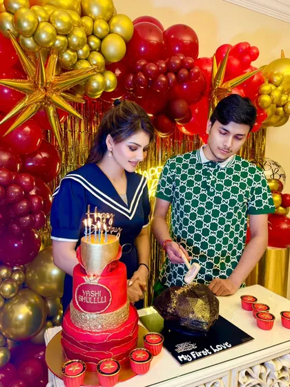 Actress Urvashi Rautela celebrating her brother Yashraj's birthday with a magnificent three-tier red and gold cake and matching cupcakes.