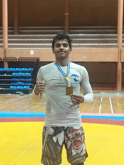 A solo shot with my gold medal at the national championship. This represents countless hours of training and sacrifice.