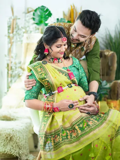 A beautiful traditional portrait of a couple in our boho studio. They are dressed in coordinating green outfits, sharing a tender moment.