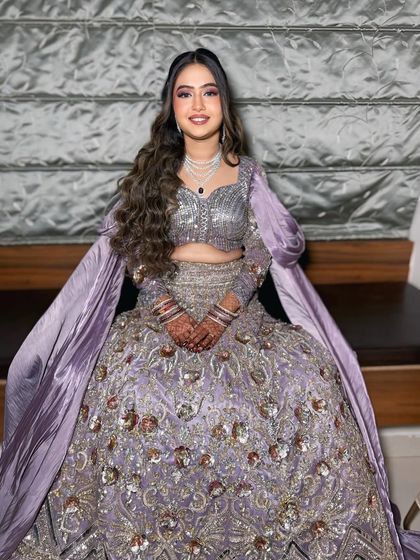 A stunning client in a lavender lehenga for an evening event. The makeup is soft and shimmery, with a focus on glowing skin and beautifully defined eyes.