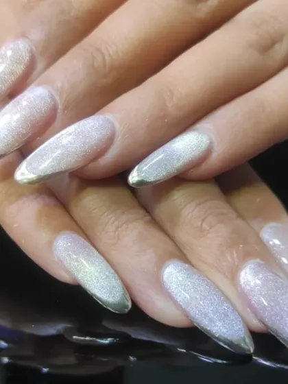 Another view of the silver glitter French tips, highlighting the sparkle and sharp stiletto shape.