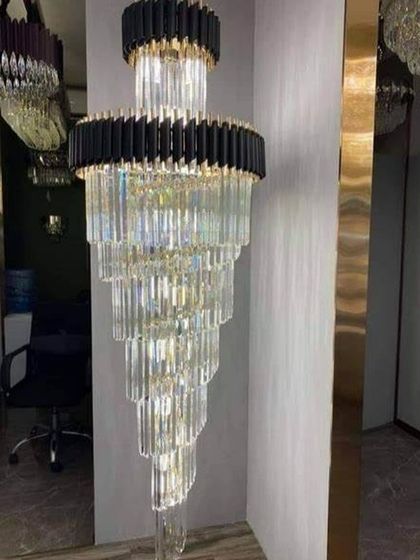 This spiral crystal chandelier features a matte black frame, offering a contemporary twist on a classic design. It is ideal for modern stairwells and foyers, providing a dramatic cascade of light.