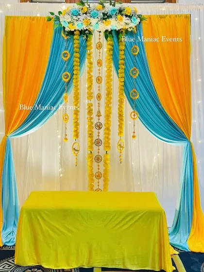 The same yellow and blue Haldi backdrop, showing the clean lines and beautiful color contrast. This setup is perfect for bringing a unique twist to your Haldi decor.