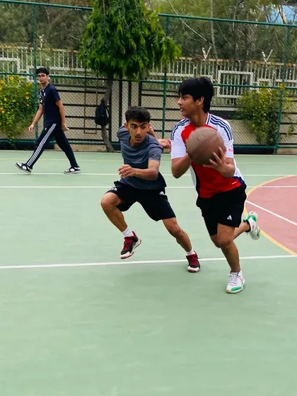 A player drives past his defender, demonstrating the dribbling skills and speed we develop in our athletes.