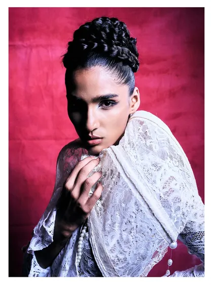 A softer, more dynamic pose from the same Flanelle editorial, showing the movement and texture of the lace garment.