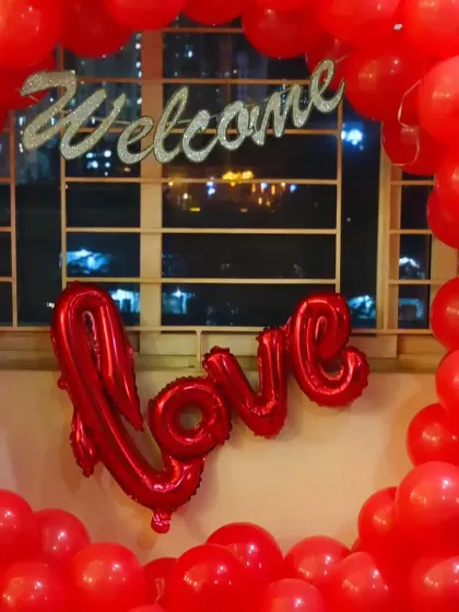 A close-up of the 'Welcome Love' balloon ring against a city night view, creating a beautiful and romantic scene.
