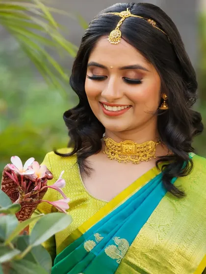A close-up of the fresh blossom engagement look, showcasing the soft makeup and how it complements the bride's sweet smile and beautiful saree.