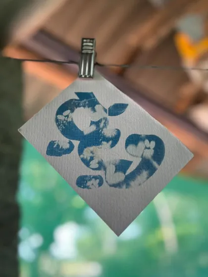An abstract cyanotype made with flowers and leaves by one of the children at Garike. They quickly took over the process, turning it into their own joyful exploration.