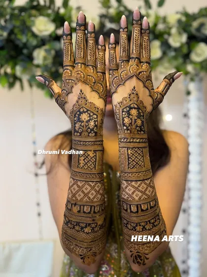 This bride wanted a grand and opulent design. I created this full-coverage mehendi with intricate floral windows, geometric jaal patterns, and delicate leafy vines on the fingers.