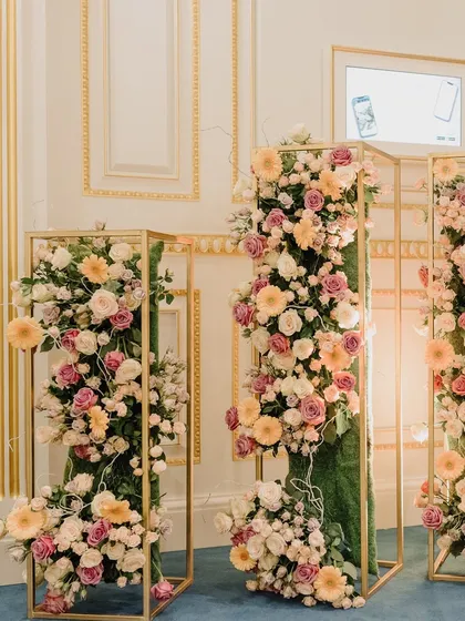 Modern floral installations in gold frames, adding a touch of contemporary artistry to the classic ballroom decor.
