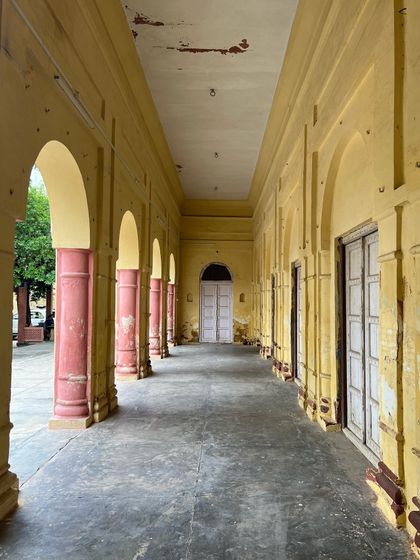 The arched verandah of the haveli, its faded colors and worn floor telling a story of a grand past that we aim to revive.