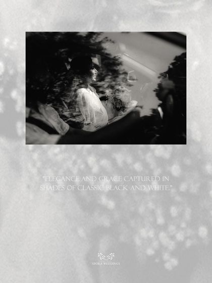 An abstract black and white shot of the couple in their car, capturing a moment of elegance and grace.